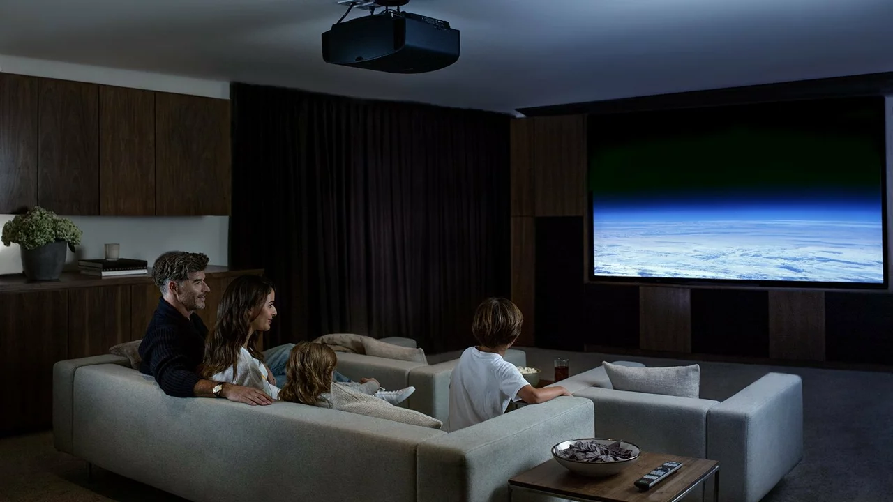 Why do movie theaters use projectors instead of TV screens?